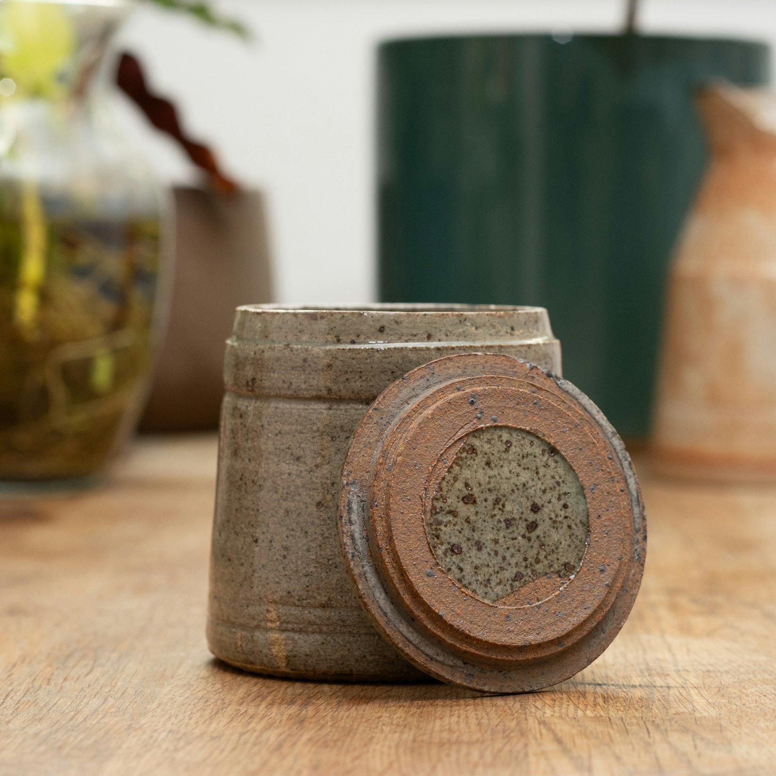 Ceramic canister with lid on a wooden surface