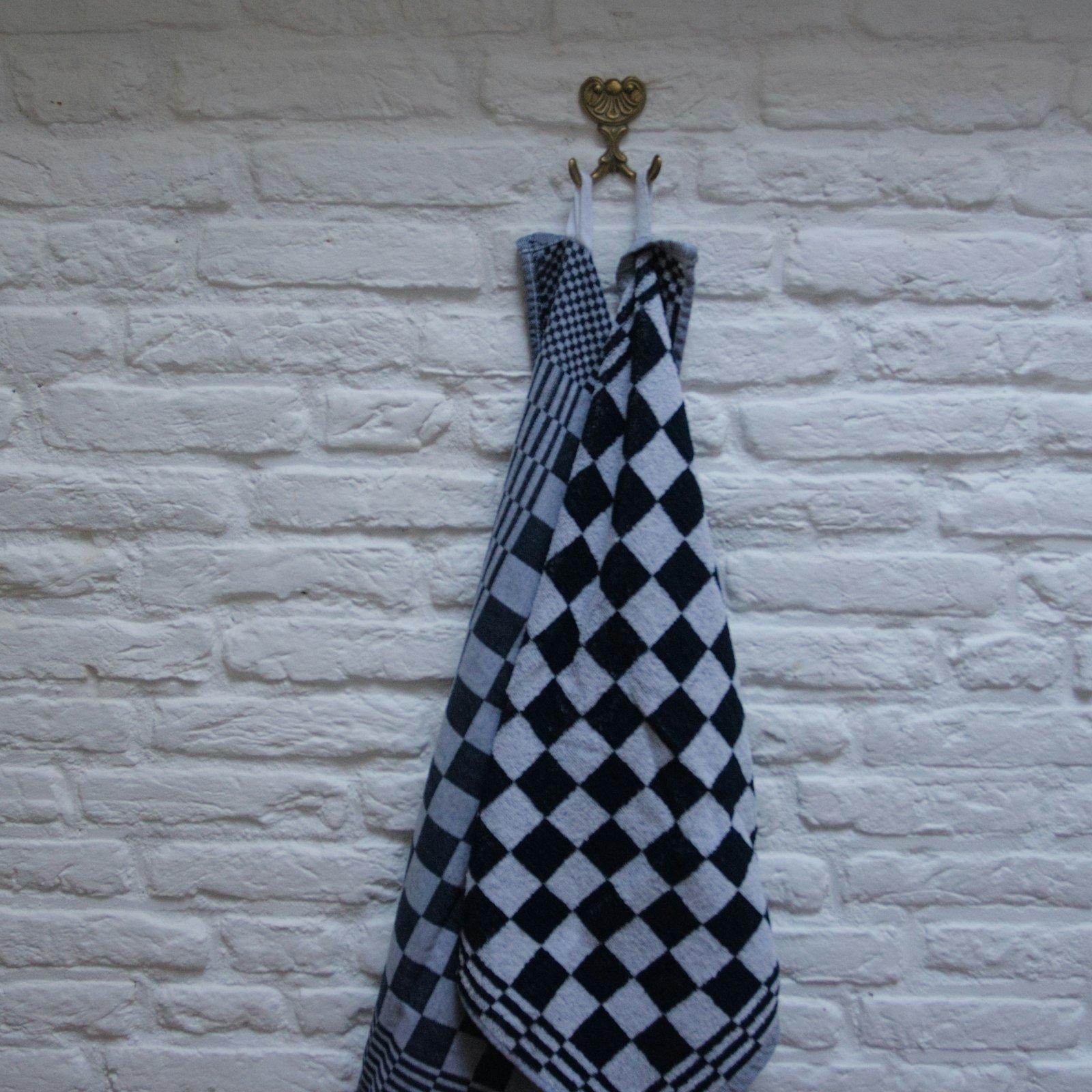 Checkered kitchen towel hanging on a hook