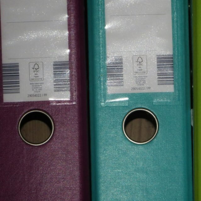 Colored ring binders on a shelf