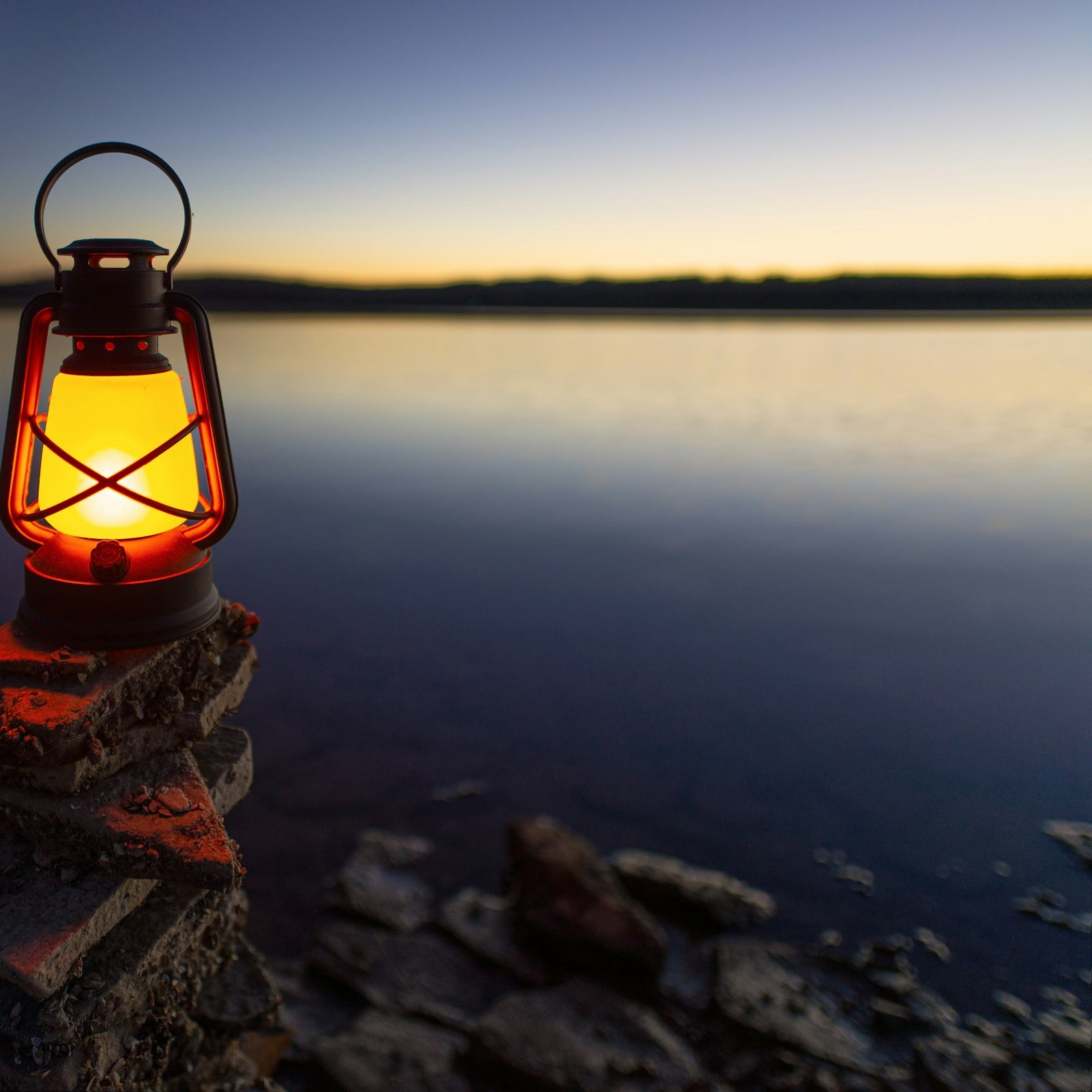 Lantern on a rock by the water