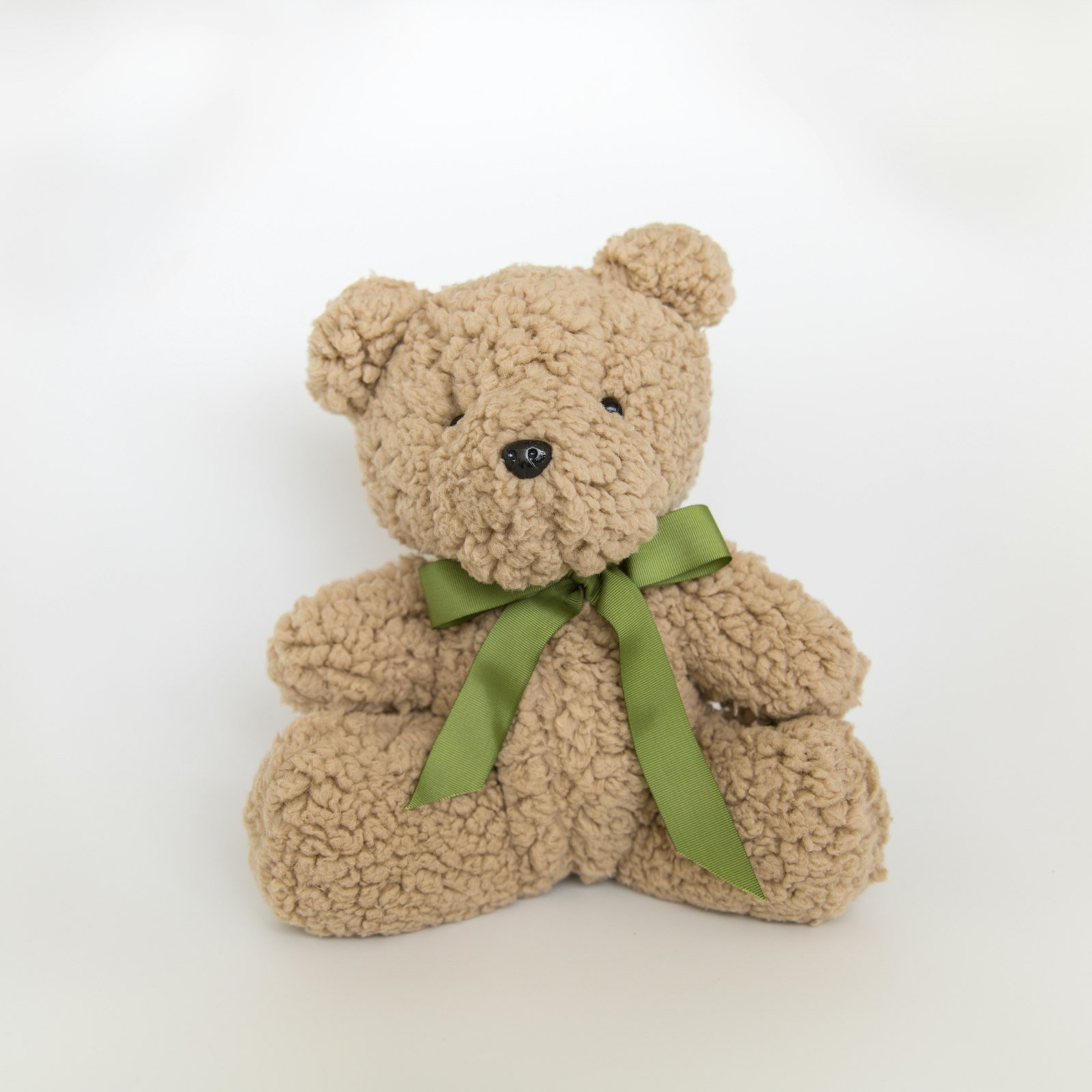 Soft plush teddy bear with a ribbon