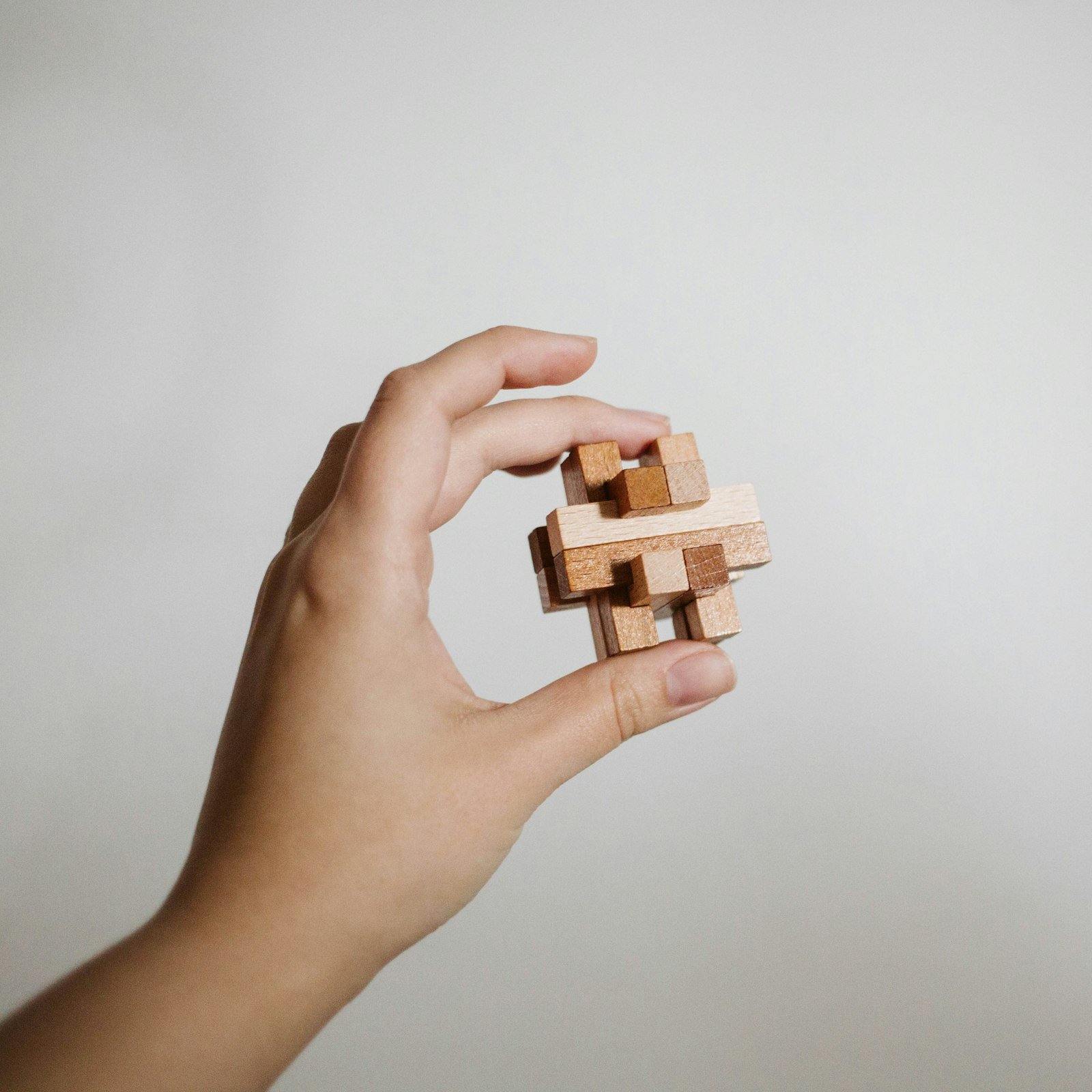Hand holding a wooden puzzle